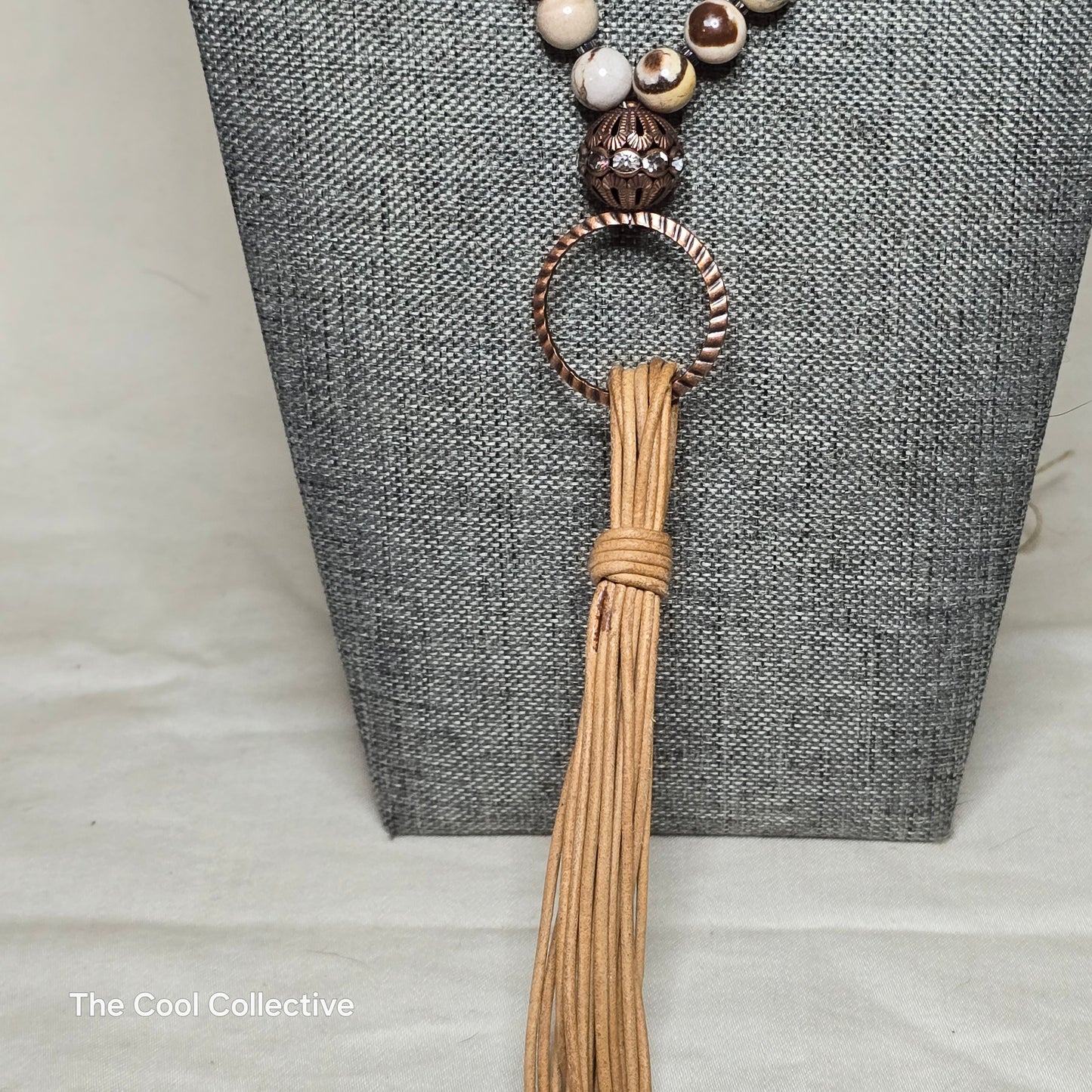 Handmade Jewelry; Zebra Jasper; Hematite; Natural Tan Leather; Adjustable Necklace; Tassel; Tina Lucas; The Cool Collective; Woman-Owned Small Business