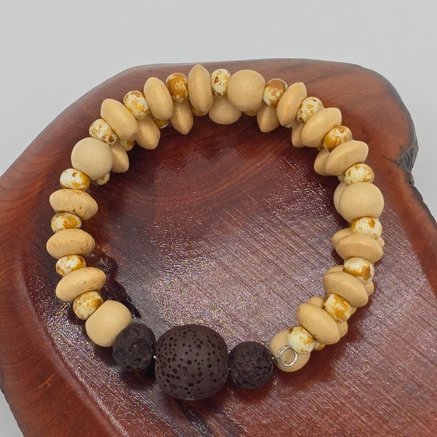 Handmade Jewelry; Memory Wire Bracelet with Cream Toned Wood. Speckled Glass Beads, and Lava Beads; Tina Lucas; The Cool Collective; Woman-Owned Small Business