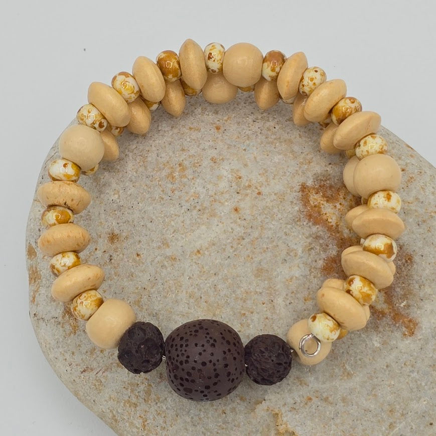 Handmade Jewelry; Memory Wire Bracelet with Cream Toned Wood. Speckled Glass Beads, and Lava Beads; Tina Lucas; The Cool Collective; Woman-Owned Small Business