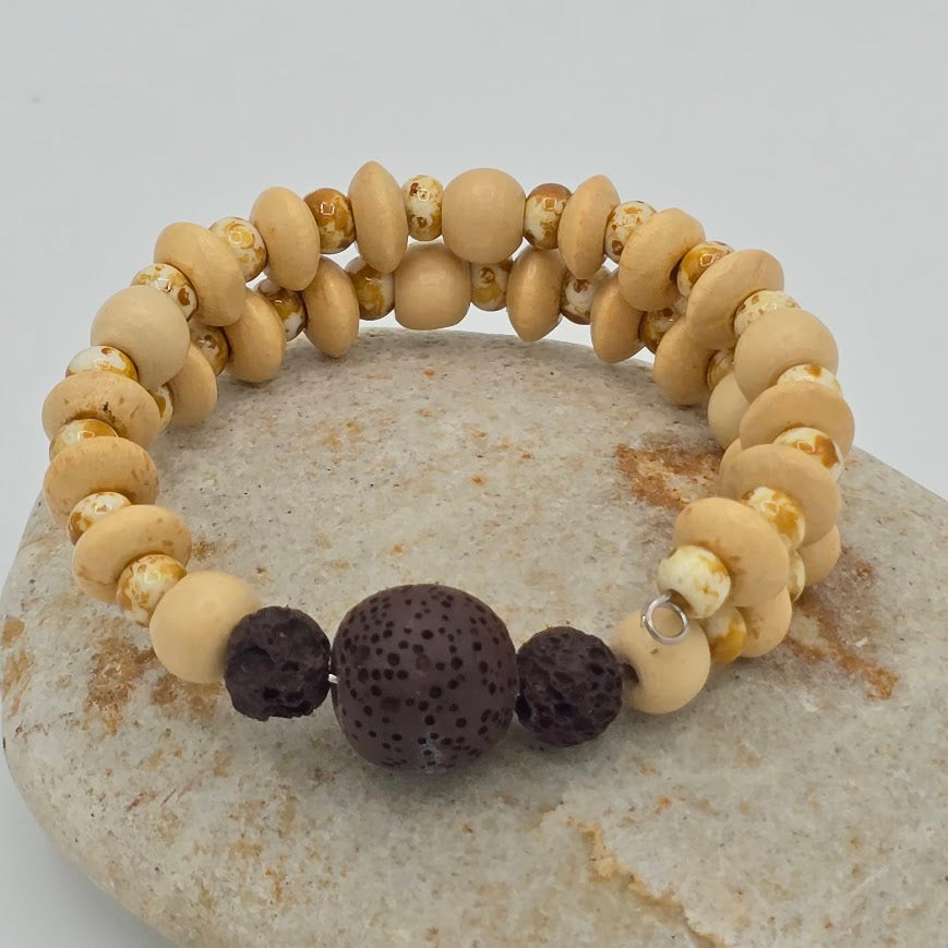 Handmade Jewelry; Memory Wire Bracelet with Cream Toned Wood. Speckled Glass Beads, and Lava Beads; Tina Lucas; The Cool Collective; Woman-Owned Small Business