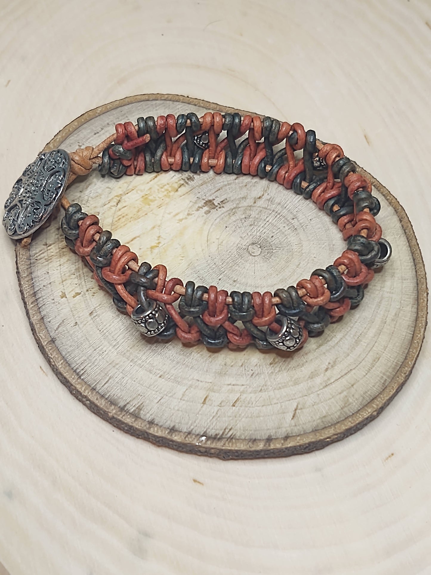Handmade Jewelry; Woven Bracelet; Natural Red Leather; Natural Blue Leather; Silver Tone Accent Beads and Button; Tina Lucas; The Cool Collective; Woman-Owned Small Business